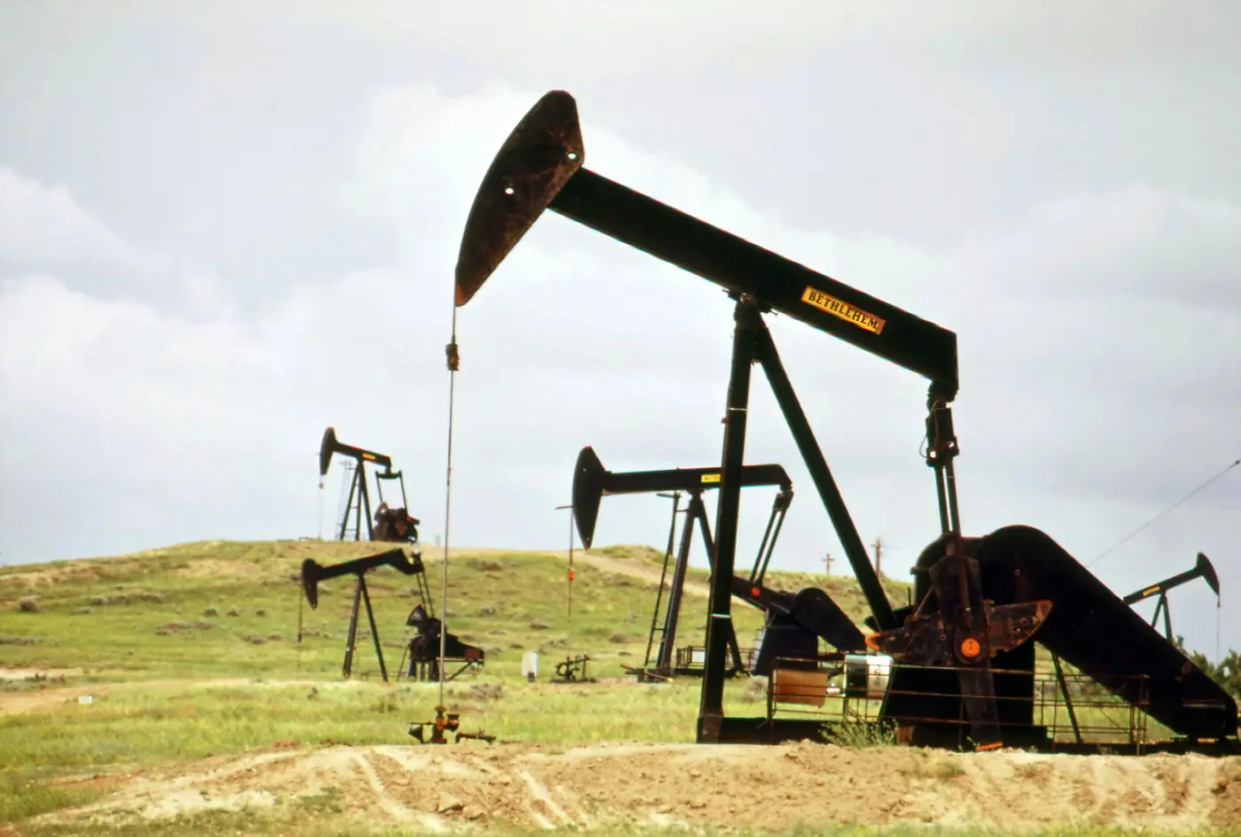 Pumpjacks in a grass field